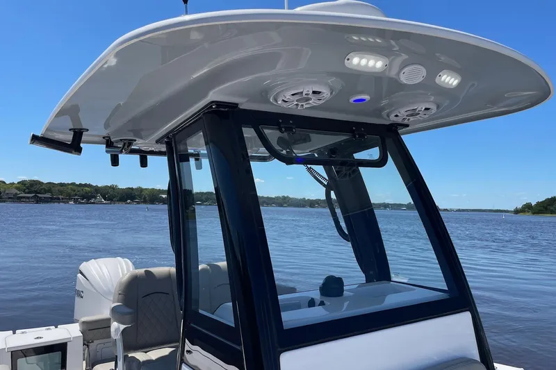 Slide: The Image of 2024 Sportsman Open 232 Center Console boat on a serene lake. - 16