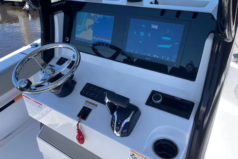 Slide: The Image of 2024 Sportsman Open 232 Center Console dashboard with steering wheel and digital displays. - 17