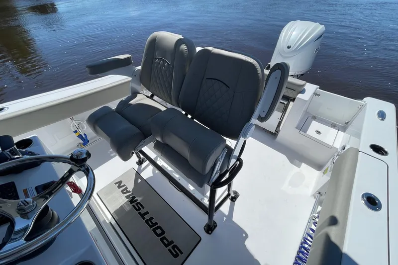 Slide: The Image of 2024 Sportsman Open 232 Center Console boat interior with dual seats and steering wheel. - 18