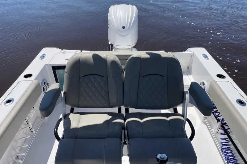 Slide: The Image of 2024 Sportsman Open 232 Center Console boat with dual seats and outboard motor. - 19