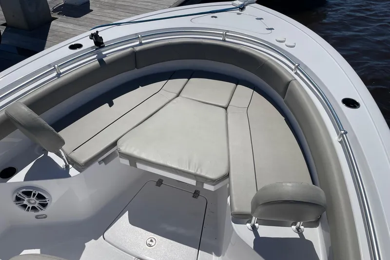 Slide: The Image of 2024 Sportsman Open 232 Center Console boat with cushioned seating and sleek design. - 26