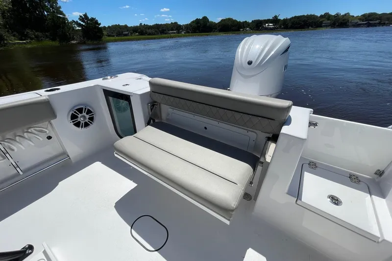Slide: The Image of 2024 Sportsman Open 232 Center Console boat interior with seating and water view. - 30