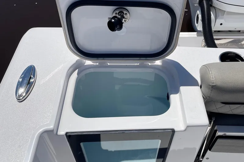 Slide: The Image of 2024 Sportsman Open 232 Center Console livewell with open lid, showcasing interior. - 33