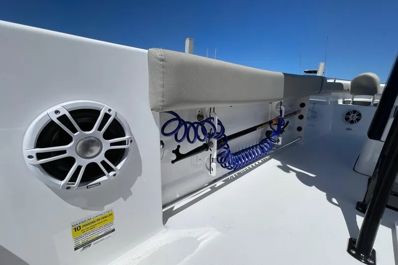 Slide: The Image of 2024 Sportsman Open 232 Center Console boat interior with speakers and rod holders. - 35