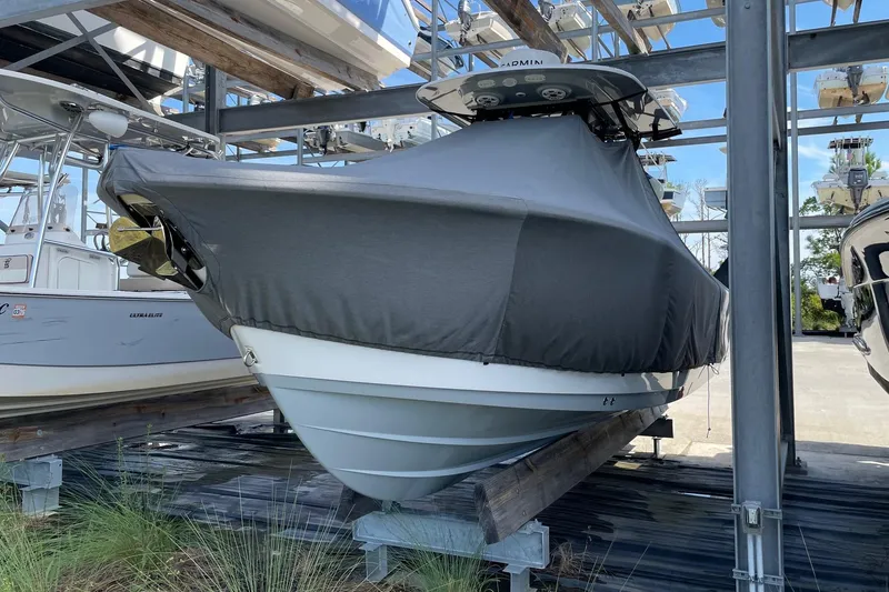 Slide: The Image of 2024 Sportsman Open 232 Center Console boat covered and stored on a rack. - 38