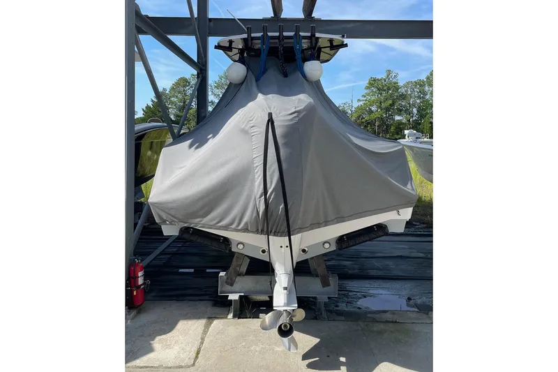 Slide: The Image of 2024 Sportsman Open 232 Center Console boat covered, stored outdoors. - 39