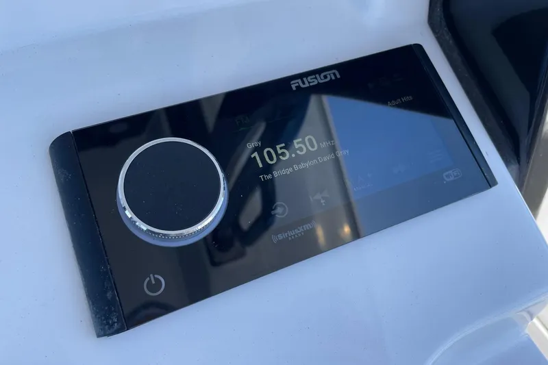 Slide: The Image of Fusion stereo system on 2024 Sportsman Open 232 Center Console boat dashboard. - 41