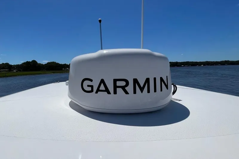 Slide: The Image of 2024 Sportsman Open 232 Center Console with Garmin radar on calm water. - 48
