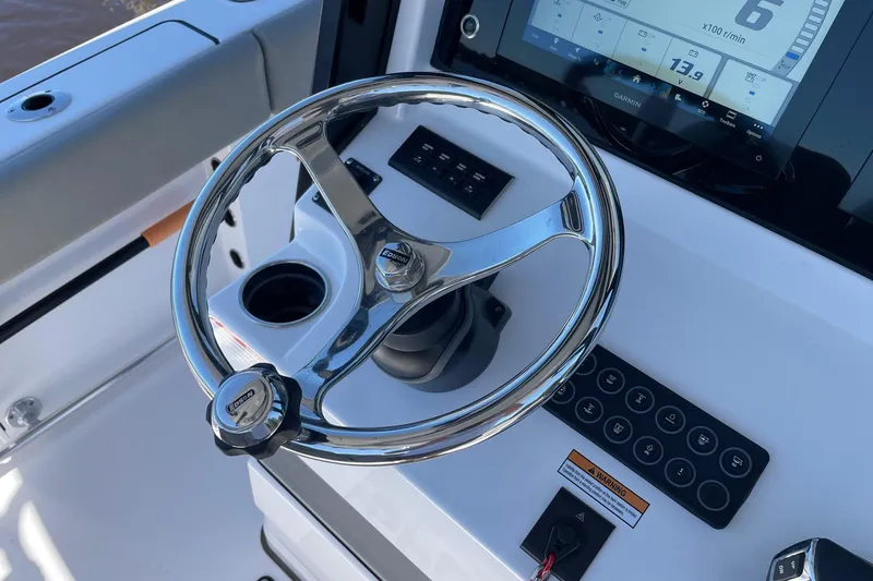 Slide: The Image of 2024 Sportsman Open 232 Center Console steering wheel and dashboard controls. - 54