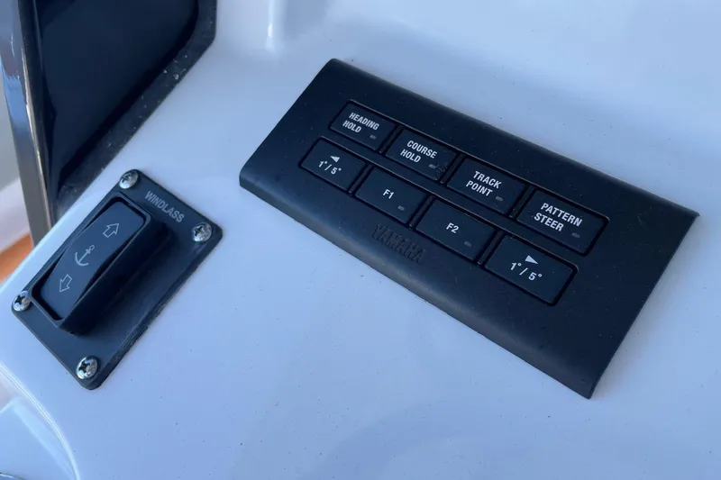 Slide: The Image of 2024 Sportsman Open 232 Center Console control panel with windlass and navigation buttons. - 55
