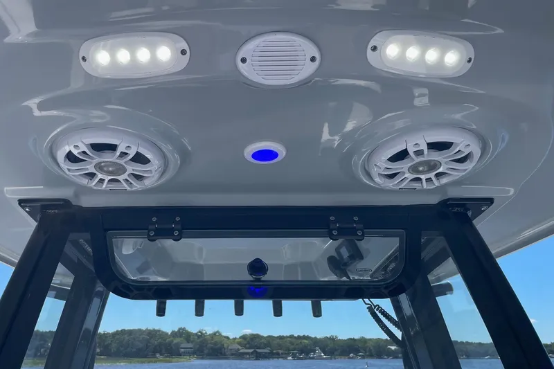 Slide: The Image of 2024 Sportsman Open 232 Center Console boat speakers and lights on T-top. - 60