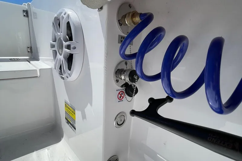 Slide: The Image of 2024 Sportsman Open 232 Center Console boat features speaker and coiled hose. - 61