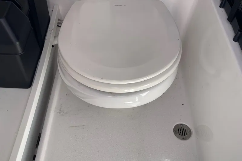 Slide: The Image of 2024 Sportsman Open 232 Center Console boat toilet area with drain. - 63