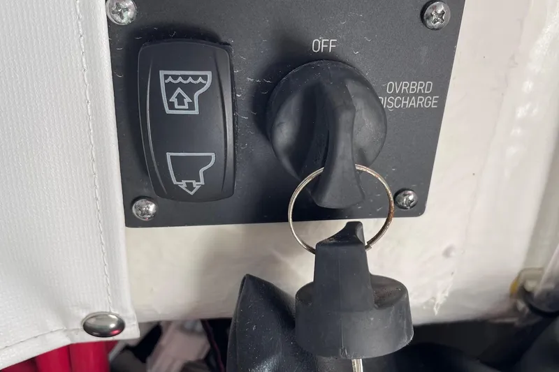 Slide: The Image of 2024 Sportsman Open 232 Center Console control panel with key and discharge switch. - 64