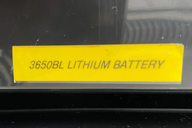 Slide: The Image of Yellow label reading "3650BL Lithium Battery" on a 2024 Sportsman Open 232 Center Console. - 68
