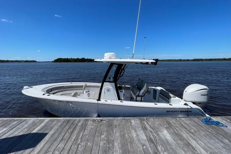 Slide: The Image of 2024 Sportsman Open 232 Center Console boat docked on a sunny day. - 7