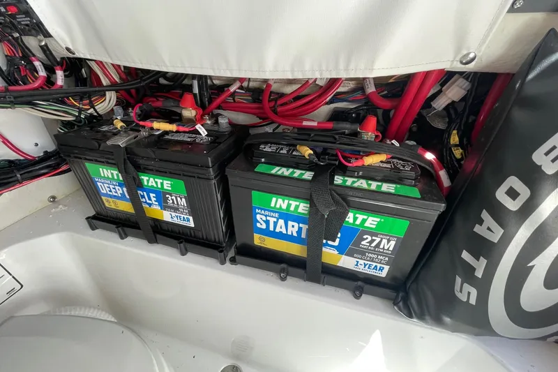 Slide: The Image of Batteries in a 2024 Sportsman Open 232 Center Console boat, featuring Interstate marine batteries. - 70