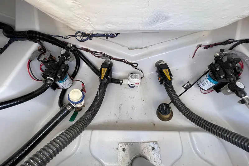 Slide: The Image of 2024 Sportsman Open 232 Center Console bilge area with pumps and wiring. - 72