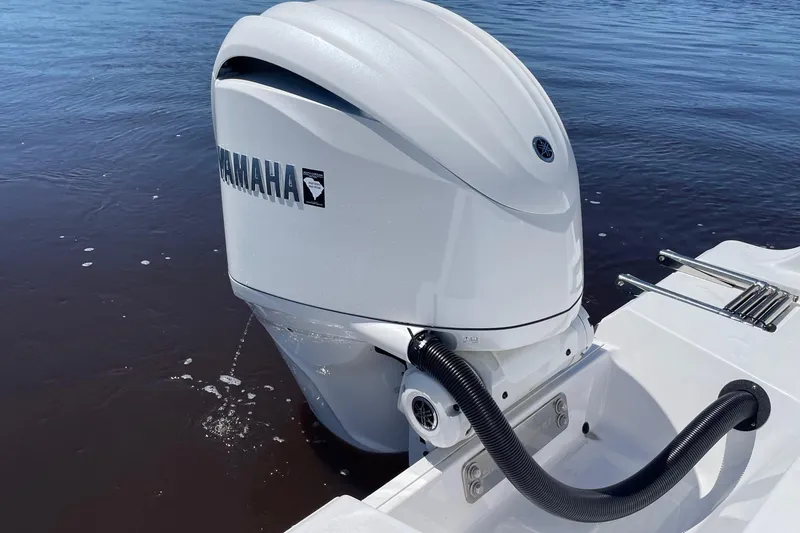 Slide: The Image of 2024 Sportsman Open 232 Center Console with Yamaha outboard engine on water. - 77