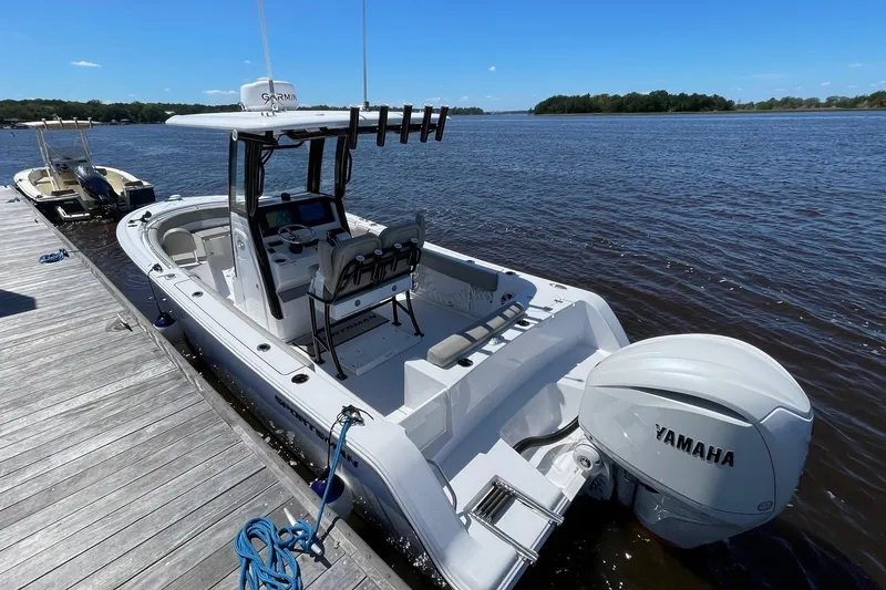 Slide: The Image of 2024 Sportsman Open 232 Center Console boat docked with Yamaha engine. - 8