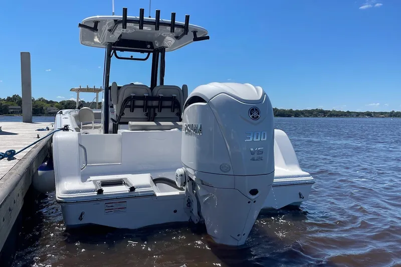 Slide: The Image of 2024 Sportsman Open 232 Center Console boat docked on a sunny day. - 9