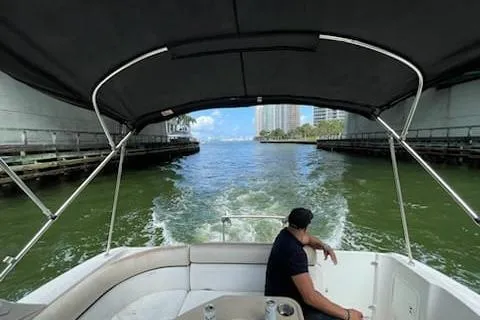 Slide: The Image of 2007 Four Winns V338 boat cruising under a bridge with a person seated. - 7