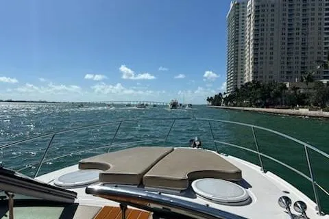 Slide: The Image of 2007 Four Winns V338 boat cruising near a city skyline on a sunny day. - 8