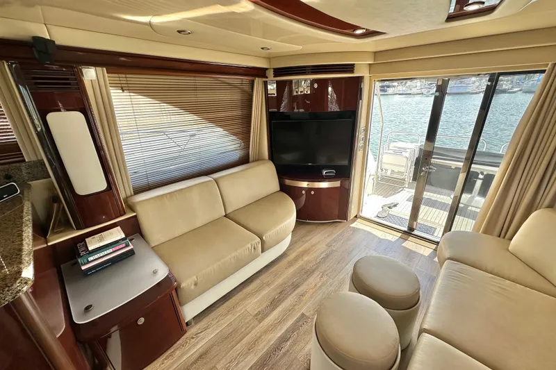 Slide: The Image of Luxurious interior of 2007 Sea Ray 580 Sedan Bridge yacht with elegant seating and waterfront view. - 14