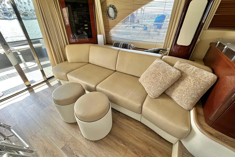Slide: The Image of Luxurious interior of 2007 Sea Ray 580 Sedan Bridge with beige leather seating and wooden flooring. - 15