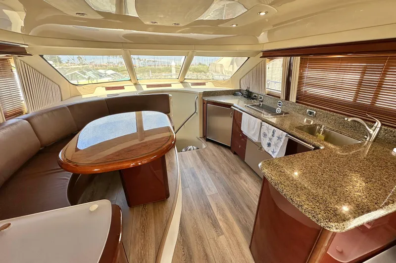 Slide: The Image of Luxurious interior of 2007 Sea Ray 580 Sedan Bridge yacht with modern kitchen and dining area. - 18
