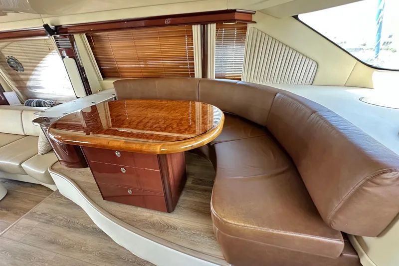 Slide: The Image of Luxurious 2007 Sea Ray 580 Sedan Bridge interior with elegant wood table and leather seating. - 19