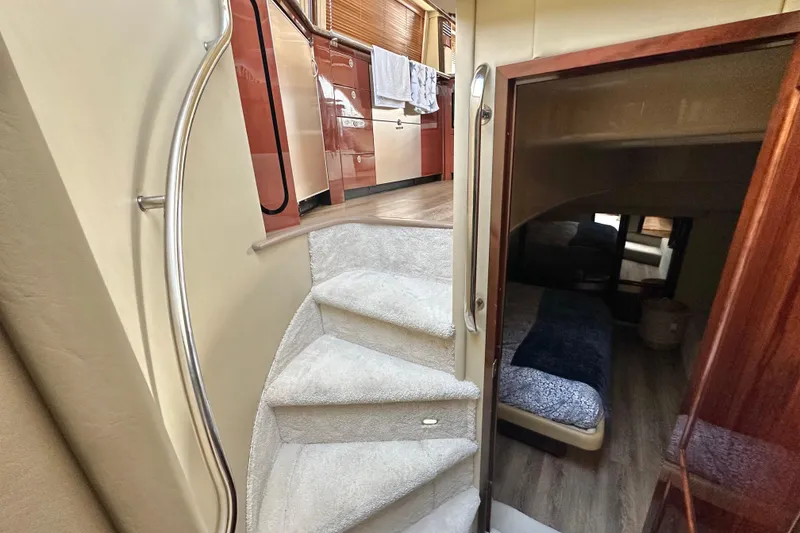 Slide: The Image of Interior of 2007 Sea Ray 580 Sedan Bridge with carpeted stairs and cozy cabin. - 20