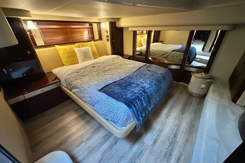 Slide: The Image of Luxurious bedroom interior of 2007 Sea Ray 580 Sedan Bridge yacht with cozy bedding. - 22