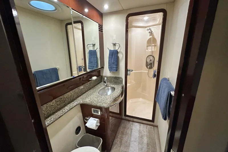 Slide: The Image of Luxurious bathroom in 2007 Sea Ray 580 Sedan Bridge yacht with granite countertop and shower. - 23