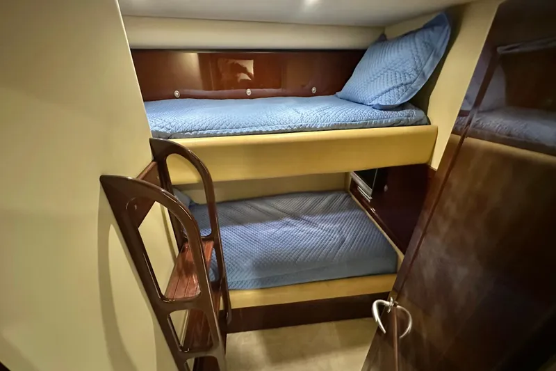 Slide: The Image of Bunk beds in 2007 Sea Ray 580 Sedan Bridge yacht cabin with blue bedding. - 26