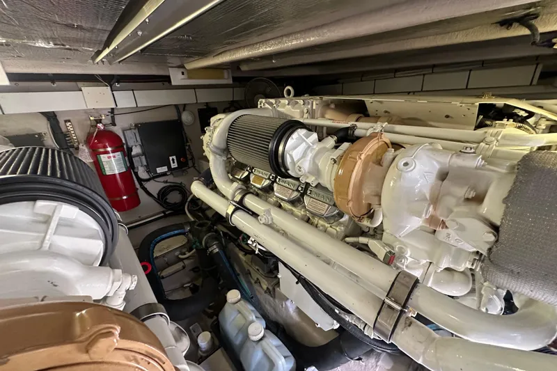 Slide: The Image of Engine room of a 2007 Sea Ray 580 Sedan Bridge with visible machinery and fire extinguisher. - 28