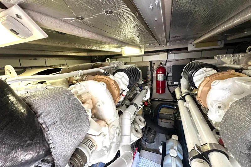 Slide: The Image of Engine room of 2007 Sea Ray 580 Sedan Bridge with visible machinery and fire extinguisher. - 29