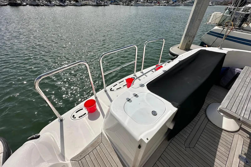 Slide: The Image of 2007 Sea Ray 580 Sedan Bridge yacht deck with railing and red buckets. - 6