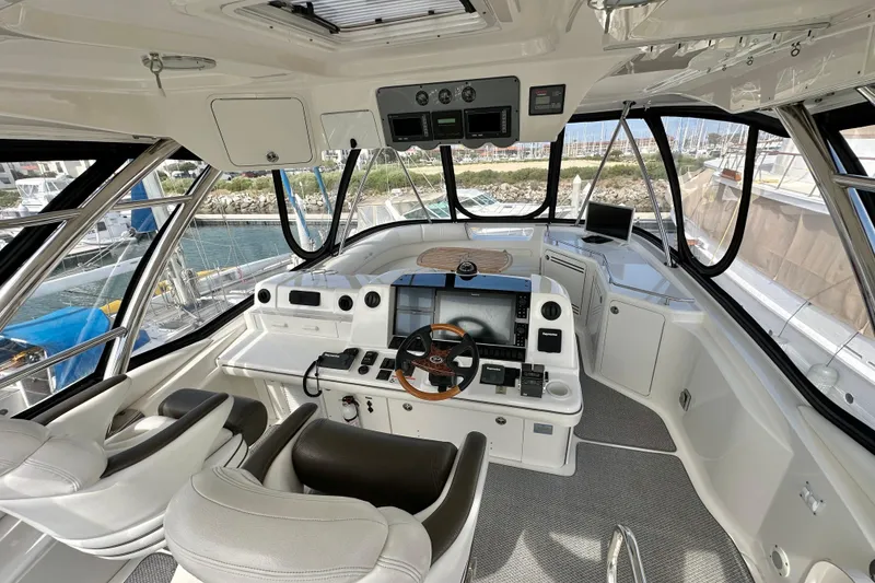 Slide: The Image of Luxurious 2007 Sea Ray 580 Sedan Bridge yacht interior with modern navigation controls. - 8
