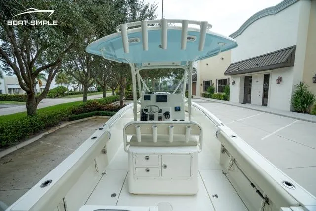 Slide: The Image of 2023 Cobia 240 Center Console boat, parked outdoors, showcasing helm and seating area. - 20