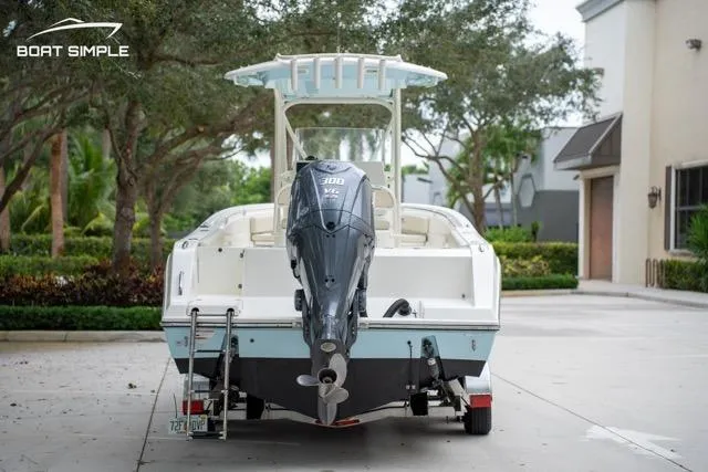 Slide: The Image of 2023 Cobia 240 Center Console boat with powerful outboard motor, parked outdoors. - 7