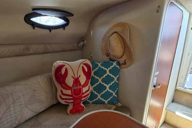 Slide: The Image of Interior of 2005 Chaparral Signature 240 with lobster pillow and straw hat. - 14