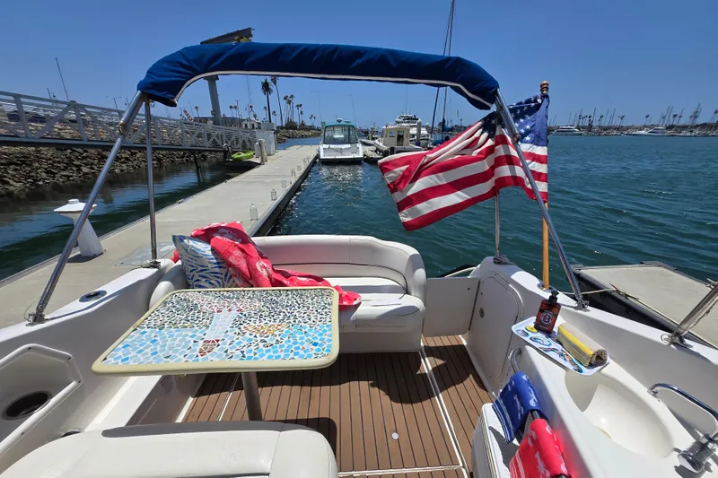 Slide: The Image of 2004 Chaparral Signature 240 boat interior with American flag, docked at marina. - 5
