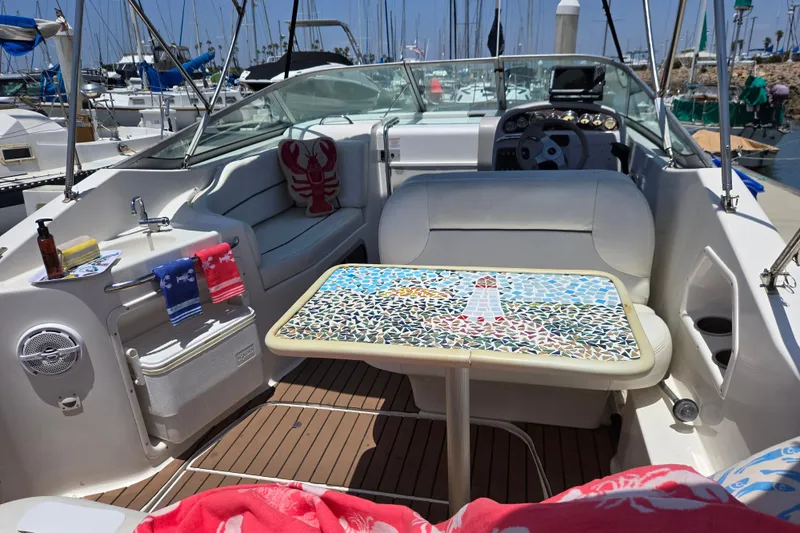 Slide: The Image of 2004 Chaparral Signature 240 boat interior with mosaic table and nautical decor. - 7