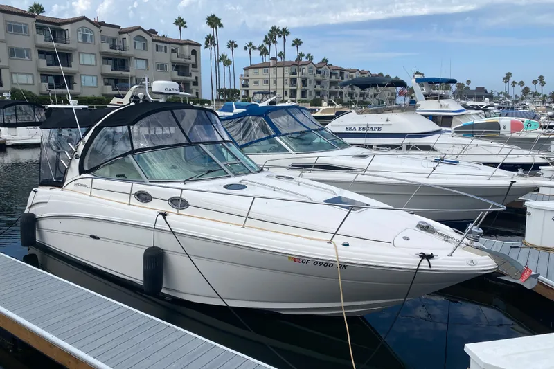 The Image of 2007 Sea Ray 300 Sundancer docked at marina with other boats. - 0