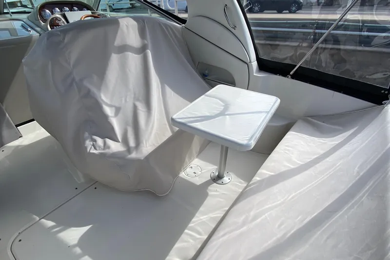 Slide: The Image of Interior of 2007 Sea Ray 300 Sundancer with covered seating and small table. - 10