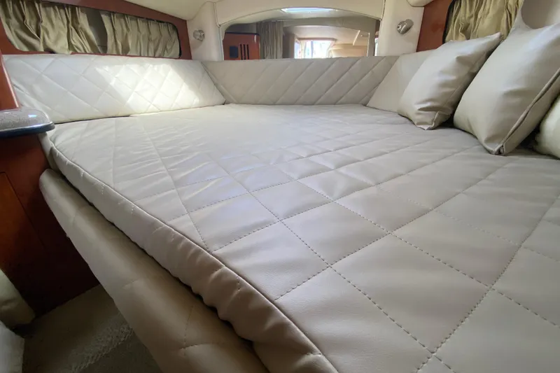 Slide: The Image of Luxurious interior cabin of 2007 Sea Ray 300 Sundancer with plush bedding. - 19