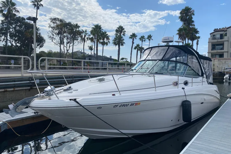 Slide: The Image of 2007 Sea Ray 300 Sundancer docked at marina with palm trees in background. - 2