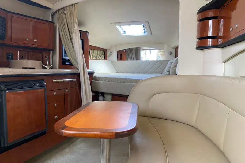 Slide: The Image of 2007 Sea Ray 300 Sundancer interior with kitchenette, seating, and sleeping area. - 22