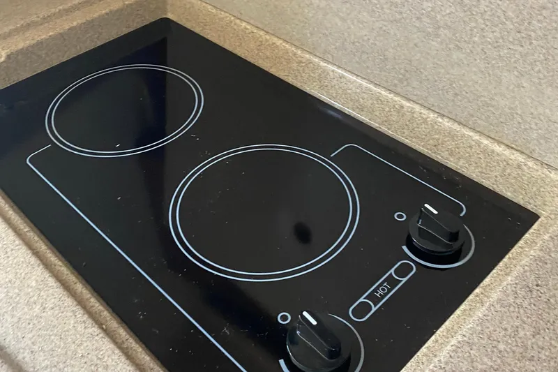 Slide: The Image of Stovetop in 2007 Sea Ray 300 Sundancer boat kitchen area. - 24